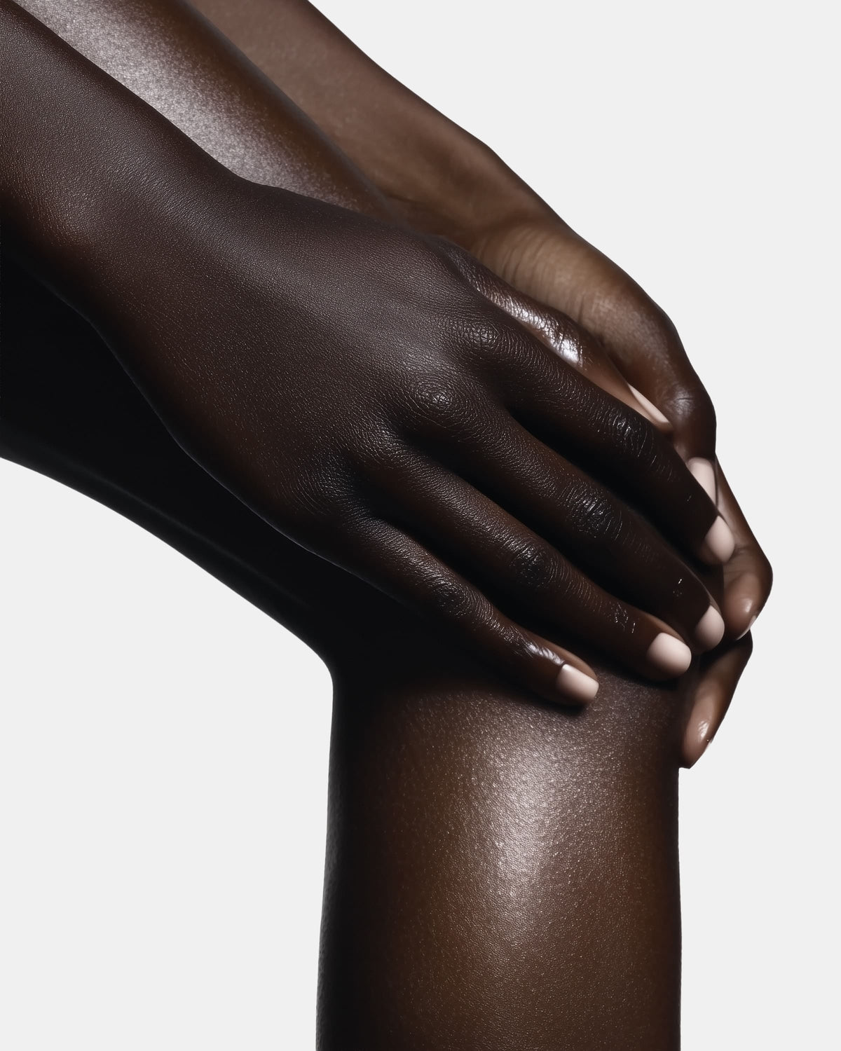 Hands on leg showing glowing, moisturized skin