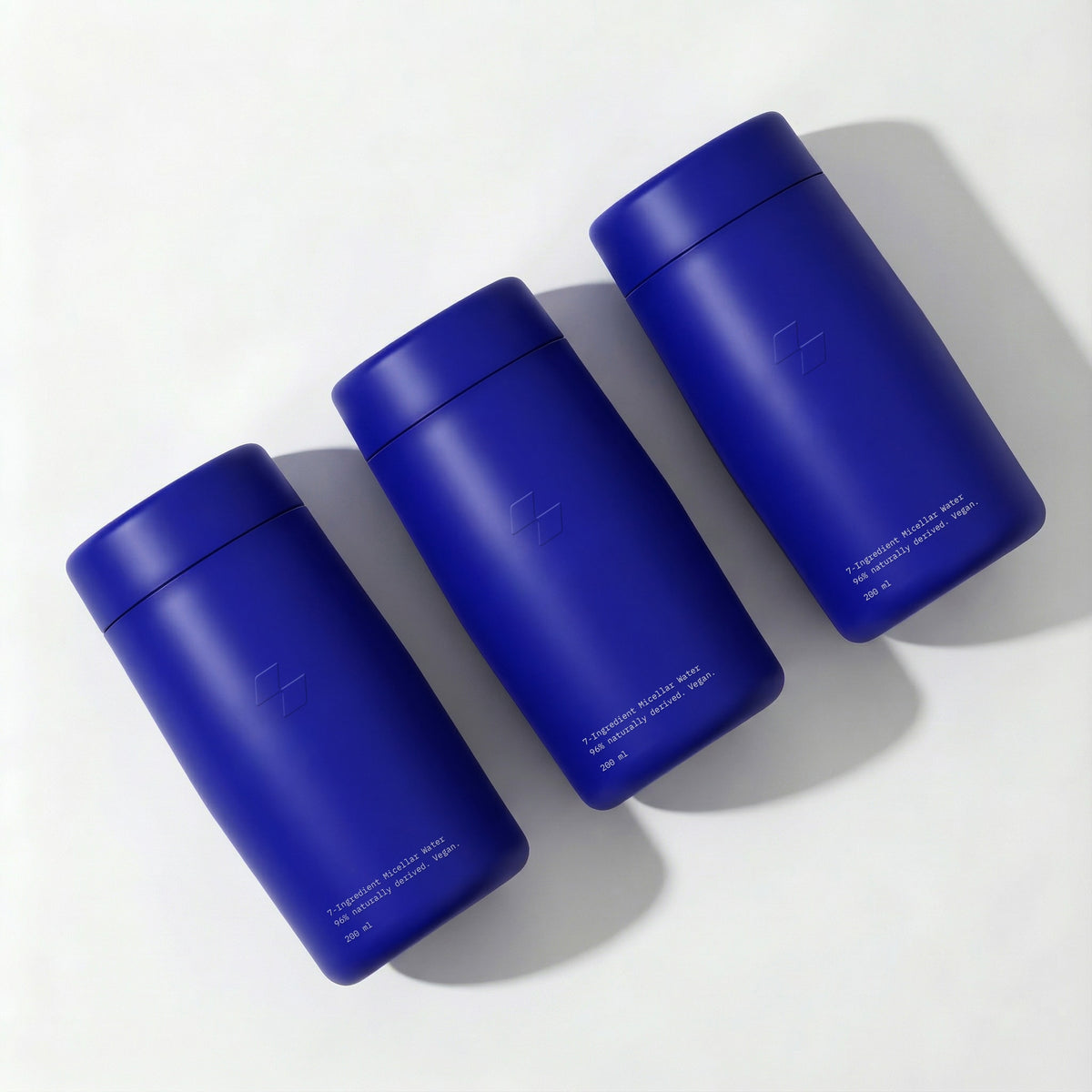Three blue thermos bottles on a white background