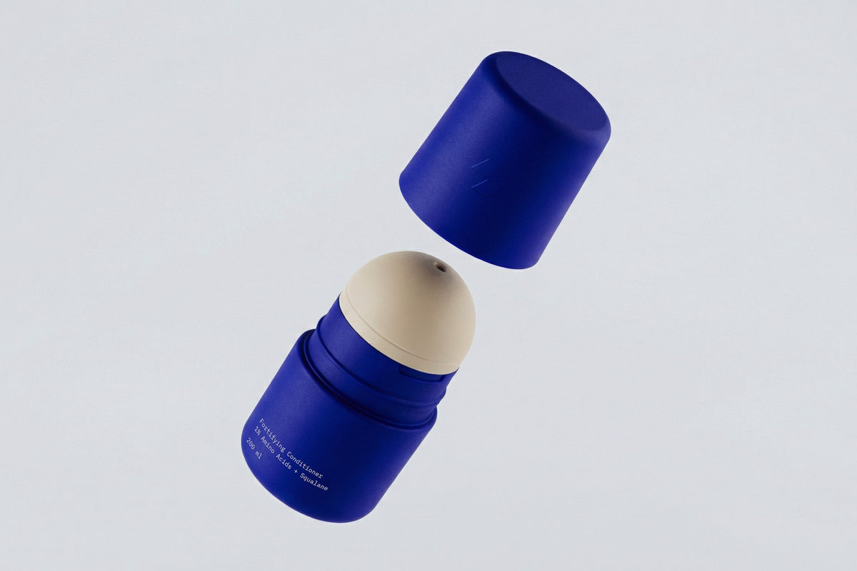Blue skincare jar with white cap shown separated