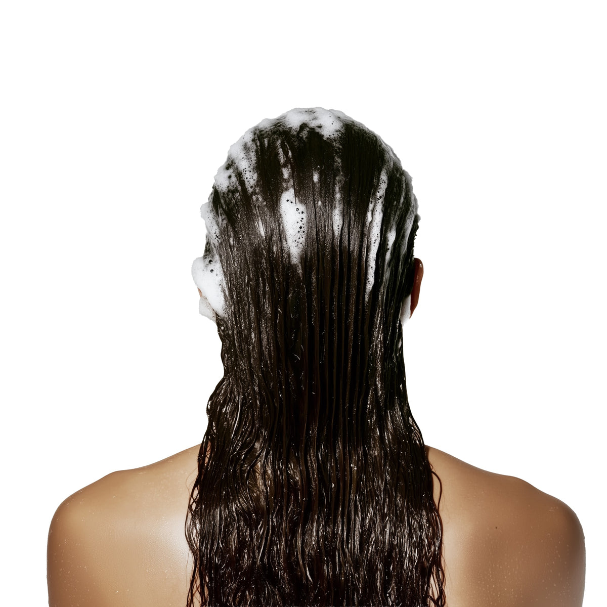 Person with wet hair covered in shampoo on a white background