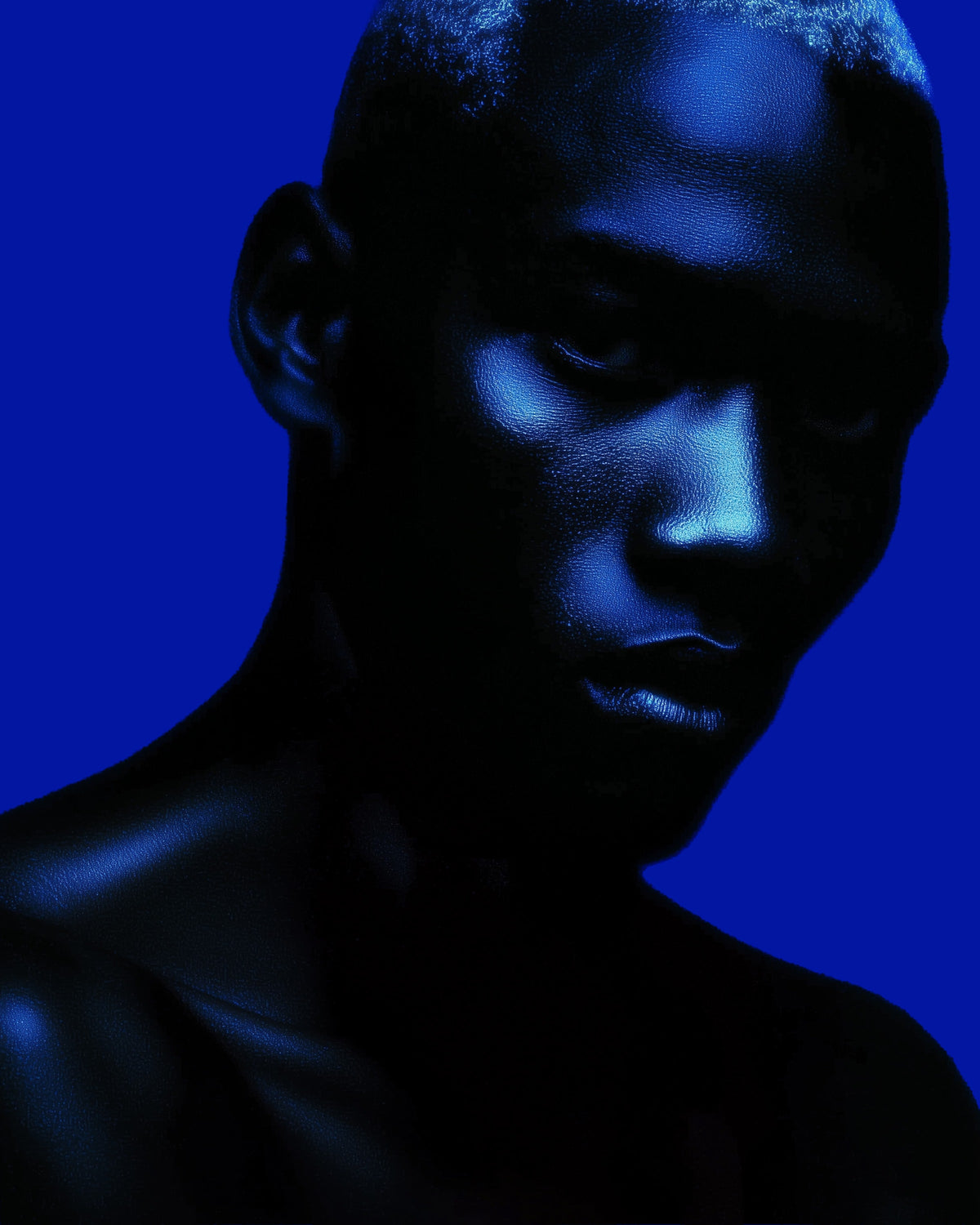 Person with blue lighting against a dark background