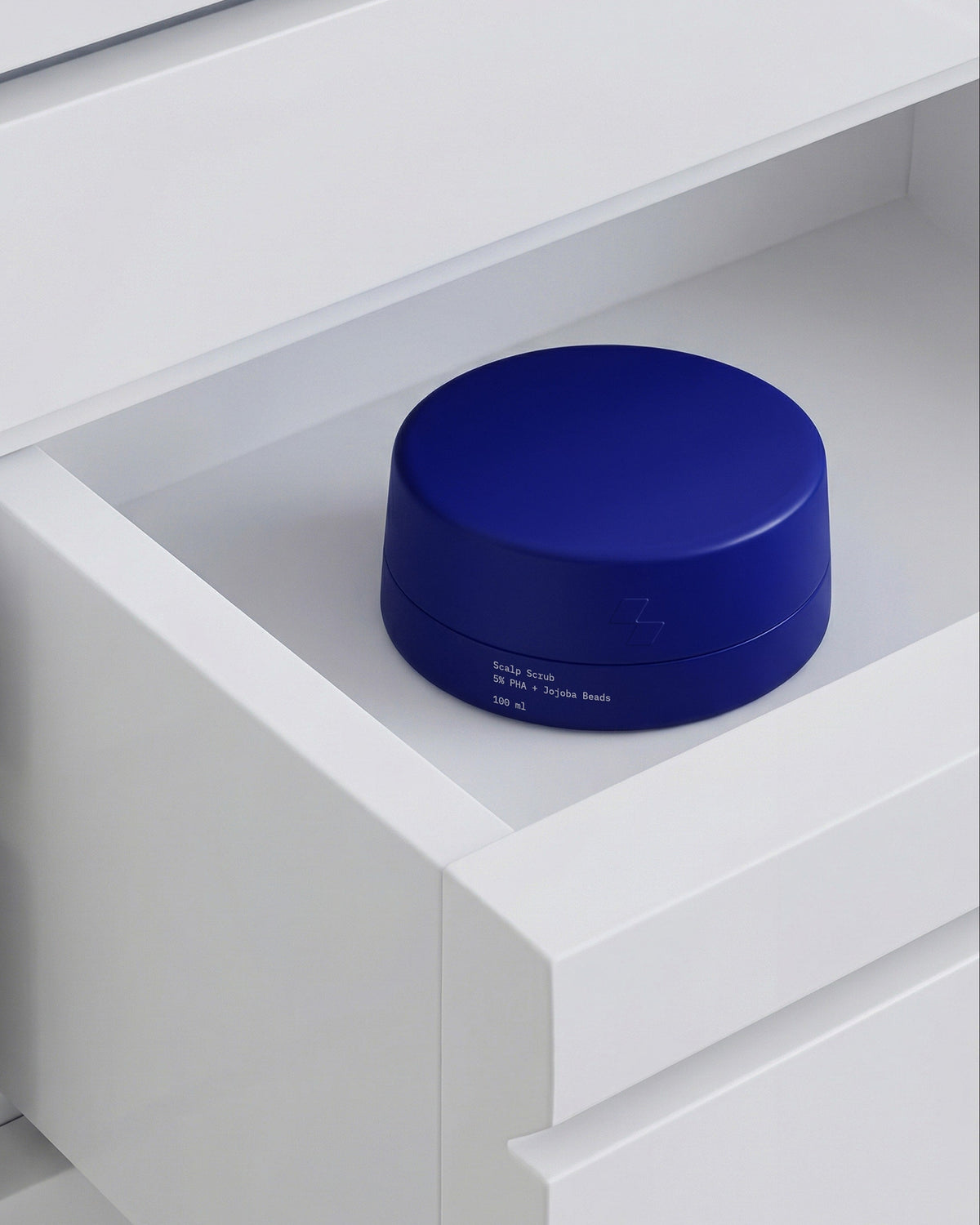 Blue cylindrical container on a white shelf