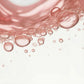 Close-up of pink bubbles on a light pink background