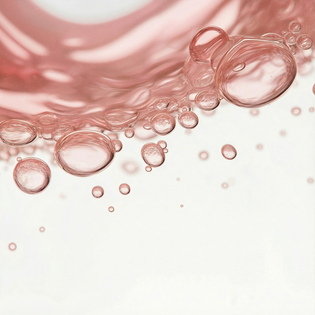 Close-up of pink bubbles on a light pink background