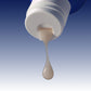 Close-up of a tube with cream dripping out on a gradient blue and gray background