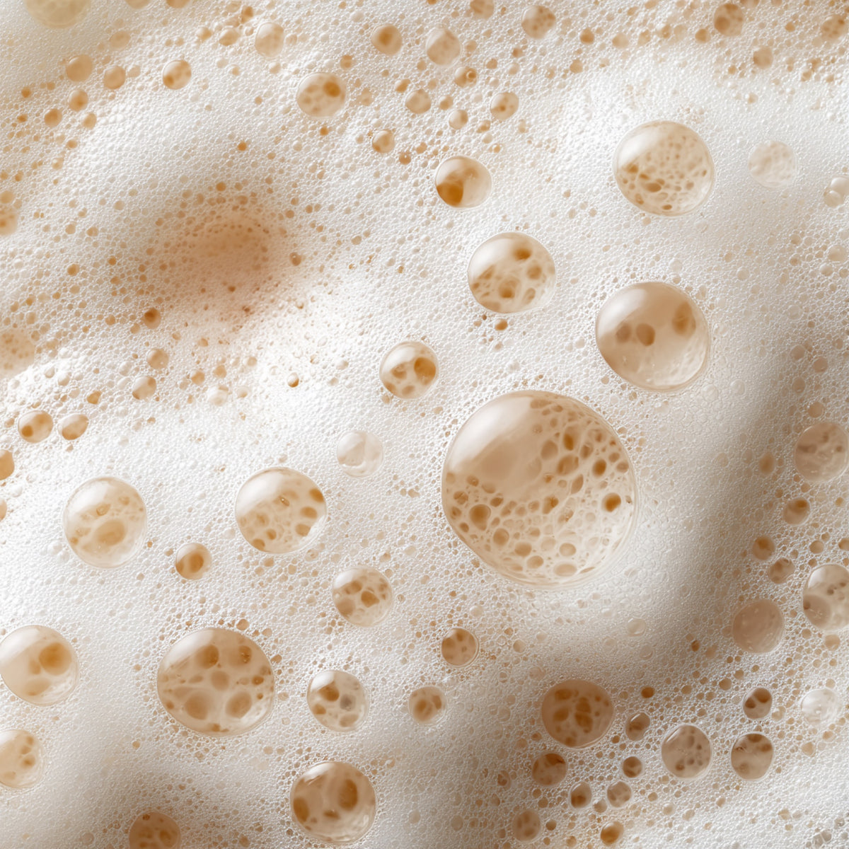 Close-up of frothy beer or coffee with bubbles