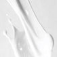 Close-up of white paint or liquid texture on a light gray background
