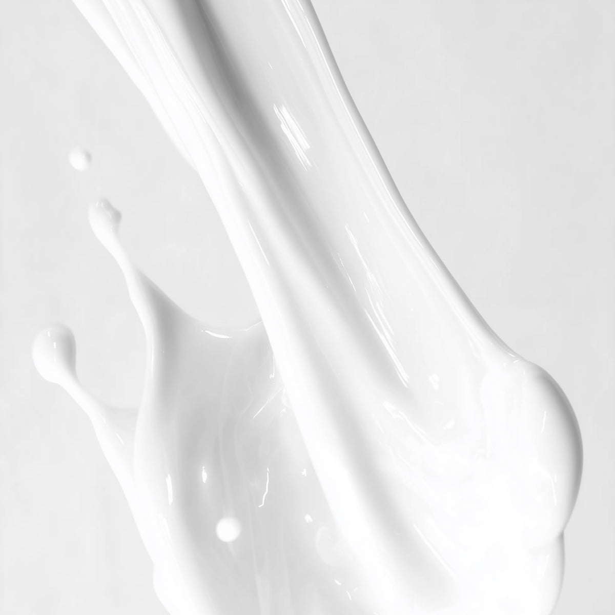 Close-up of white paint or liquid texture on a light gray background