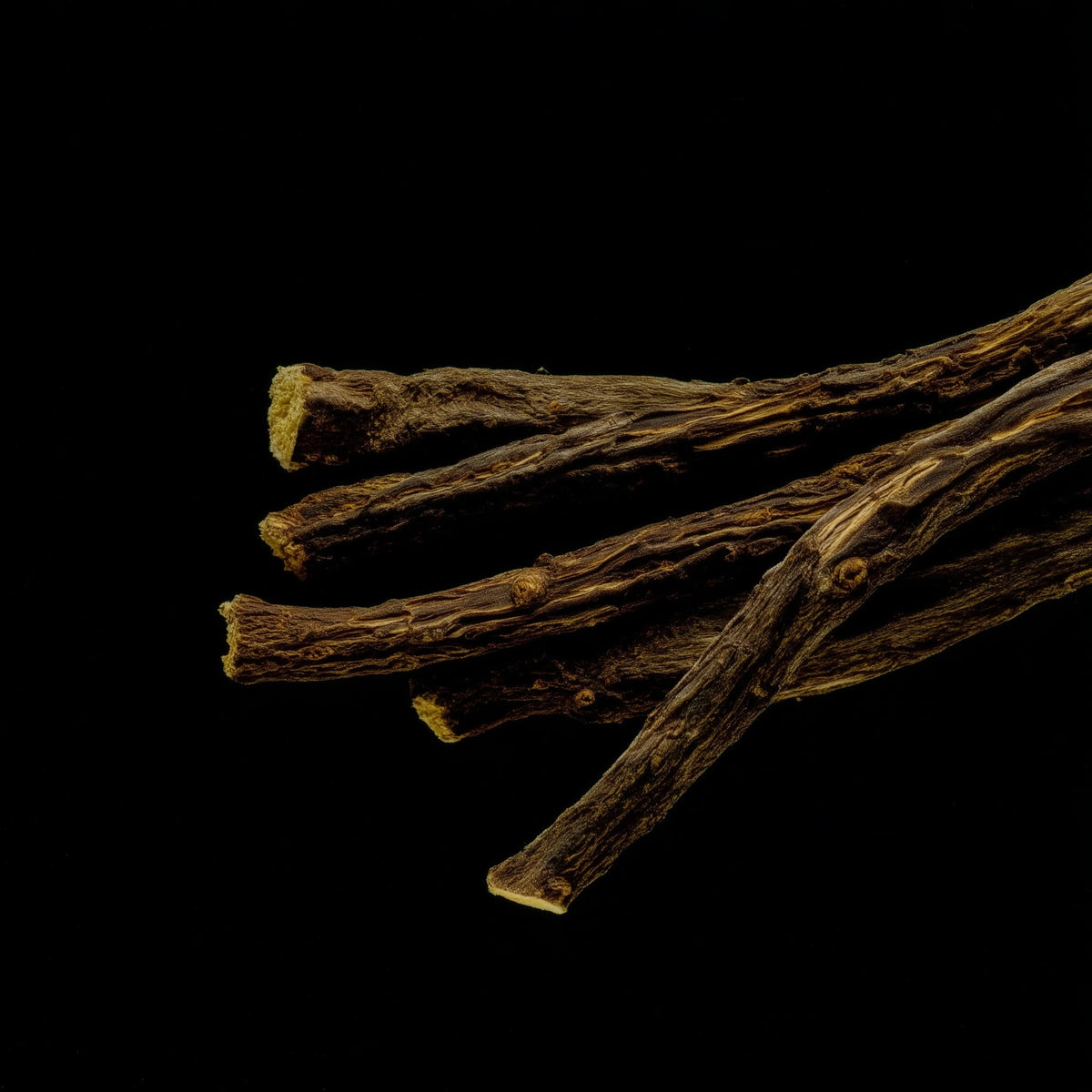 Dried licorice roots on a black background