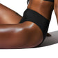 Black bikini bottom worn by a person on a white background