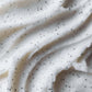 Close-up of white whipped cream with black specks
