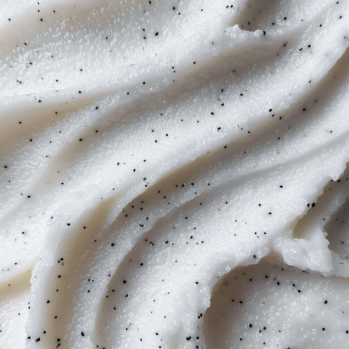 Close-up of white whipped cream with black specks