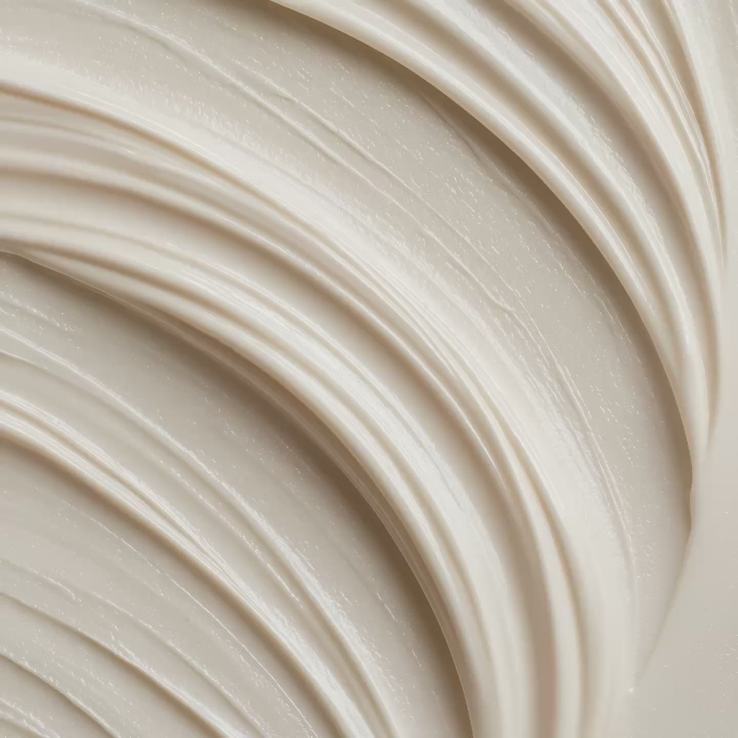 Smooth beige moisturizing cream with soft swirled texture