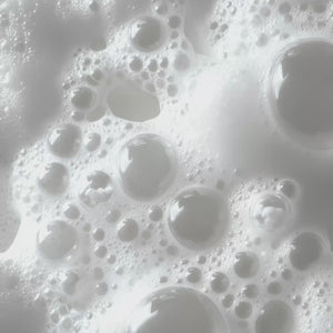 Macro view of white foaming product with various sized bubbles