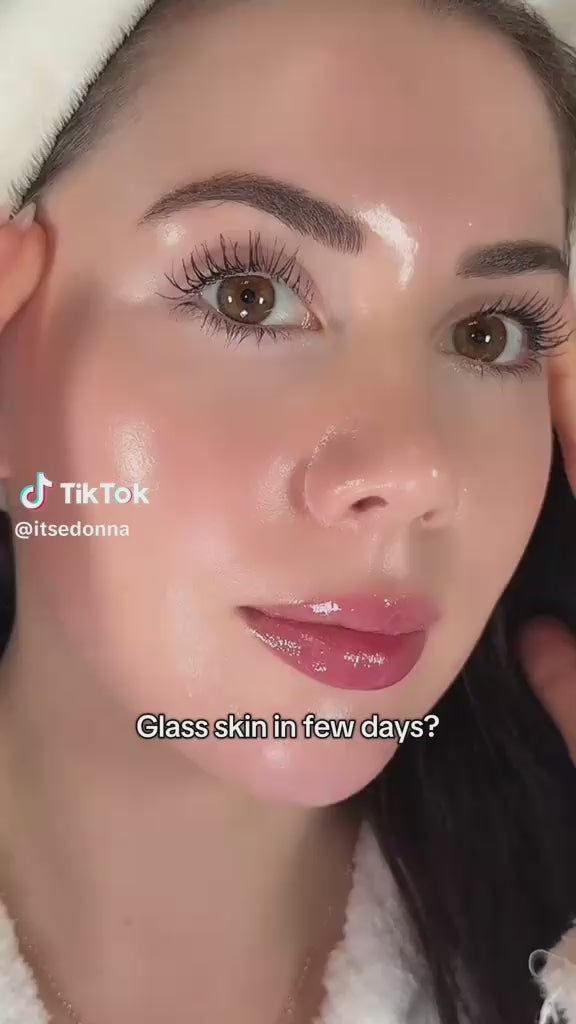 Woman with glass skin effect showing luminous, glowing complexion and long lashes