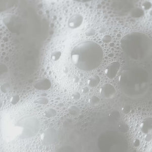 Close-up of white foam and bubbles from cleansing product
