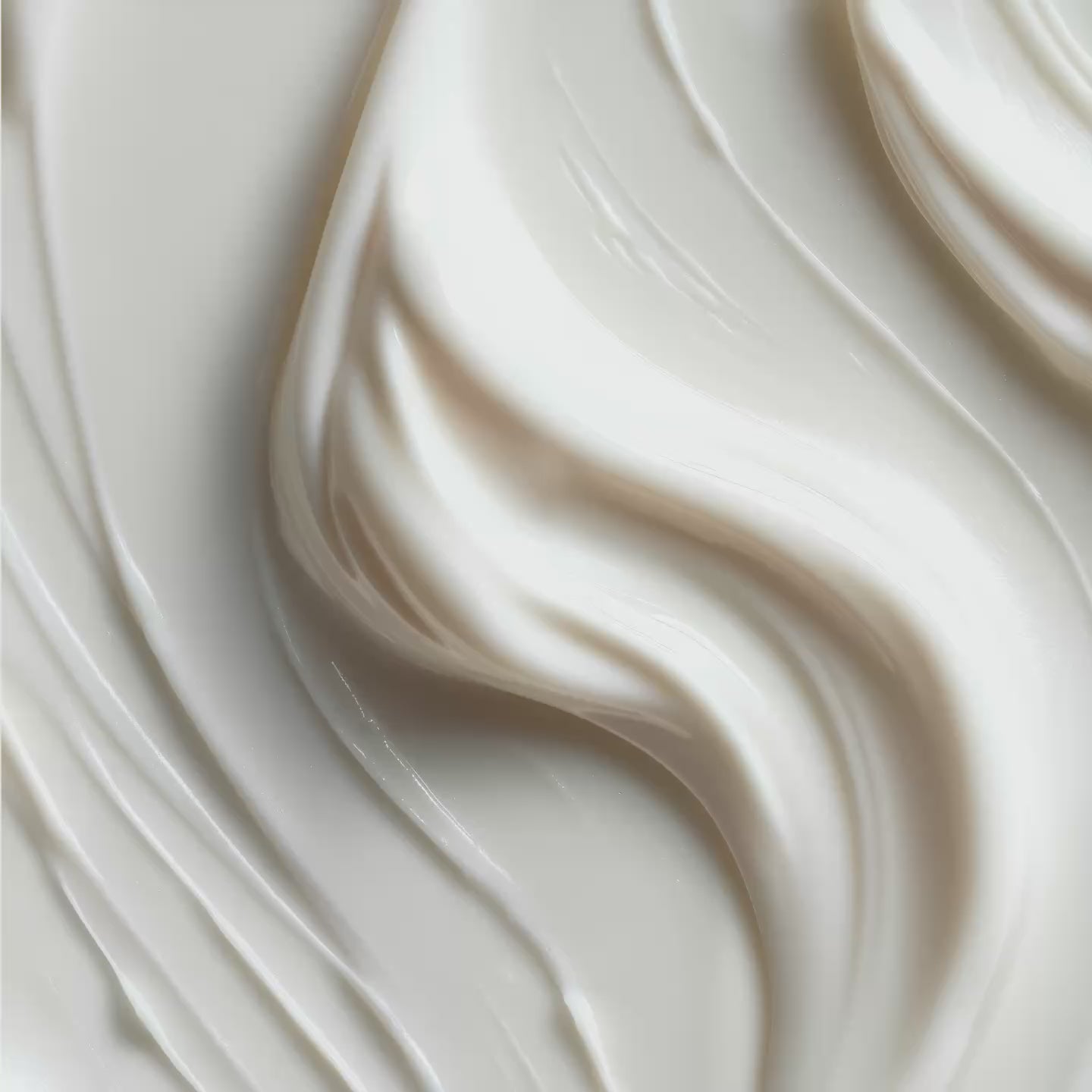 Close-up of white cream with smooth swirled texture