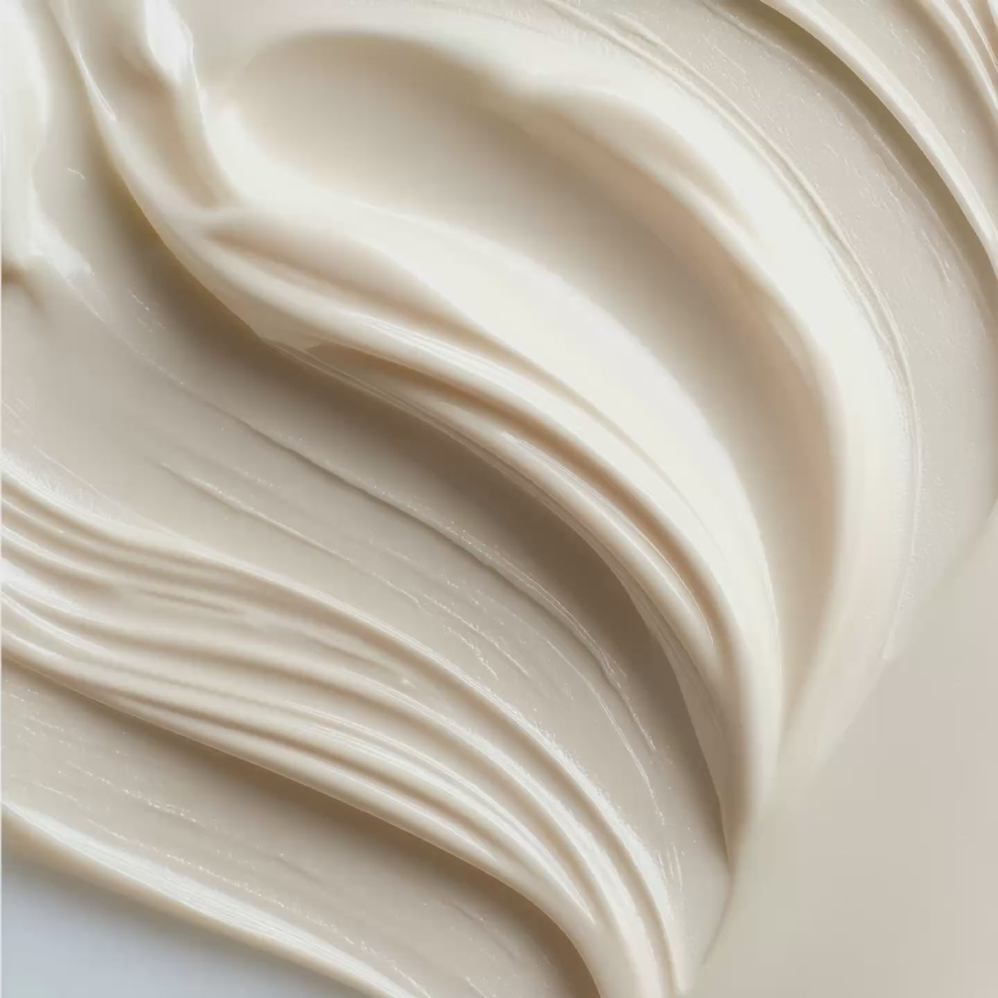 Luxurious white moisturizing cream with silky swirled texture