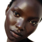 Close-up of a person's face with a neutral expression on a white background
