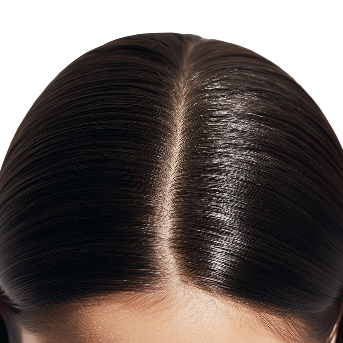 Close-up of a person's scalp with shiny, well-maintained hair.