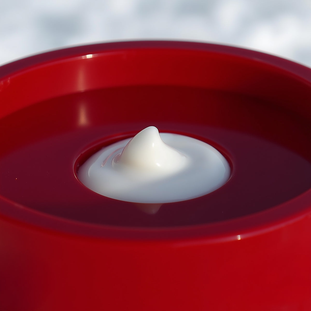White Hershey's Kiss candy on a red background