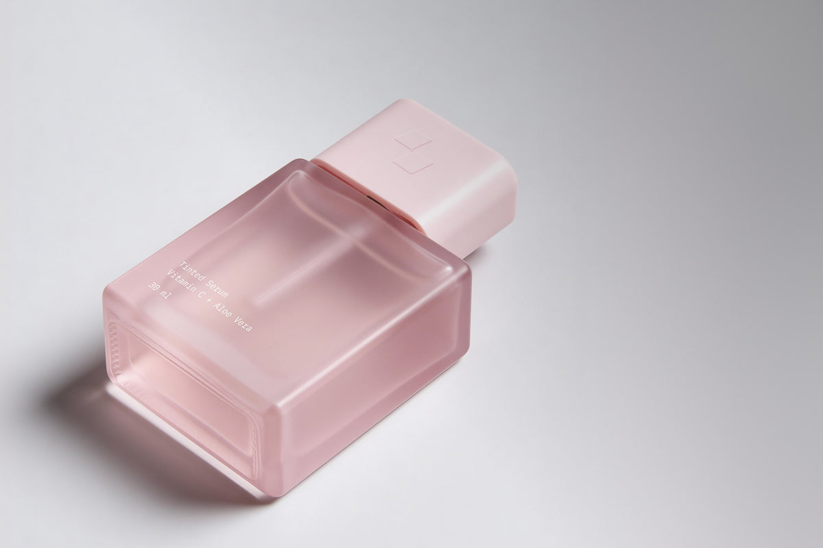 Pink serum bottle with pump dispenser