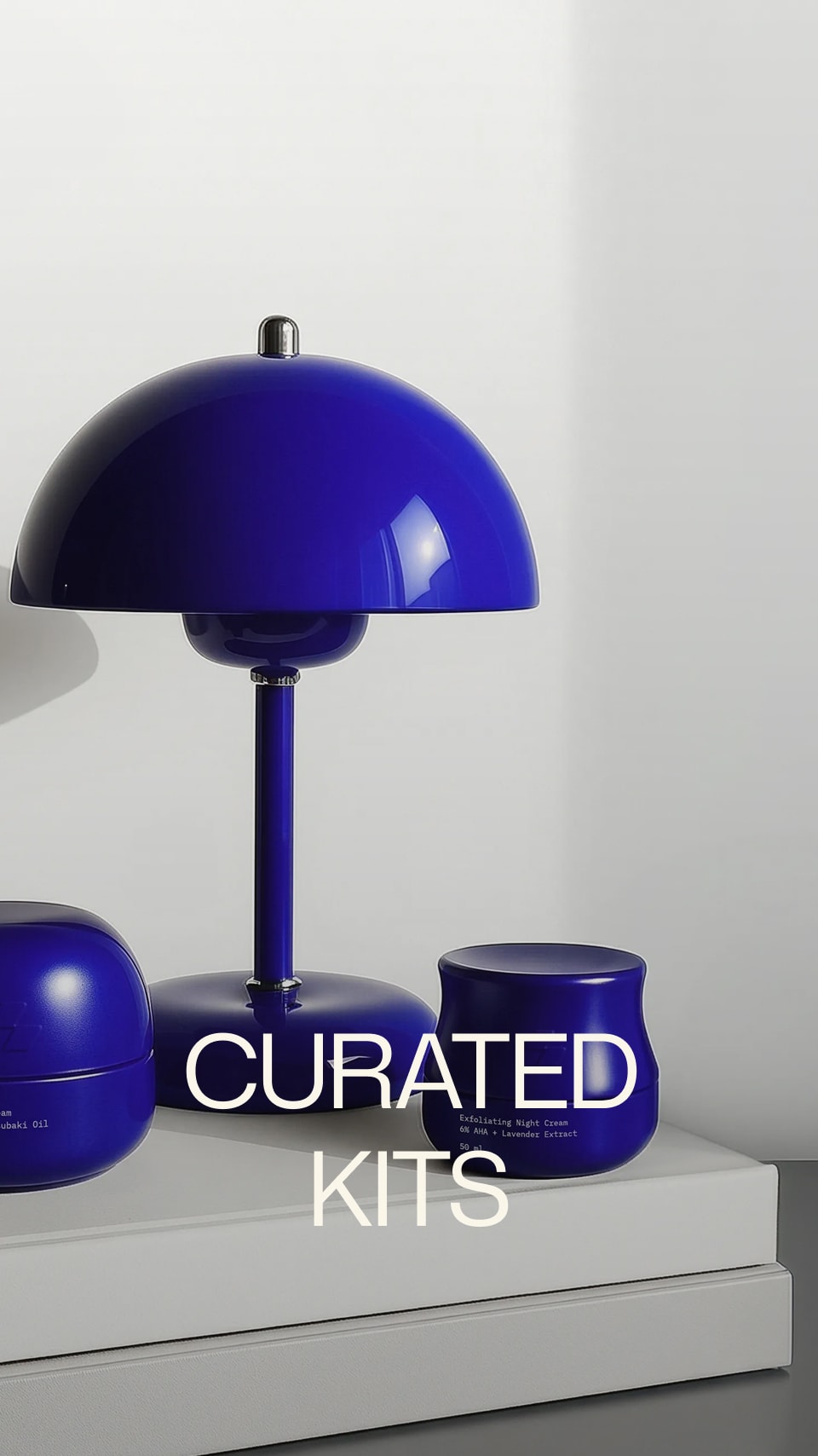 Blue lamp and jars on a white surface with 'Curated Kits' text.