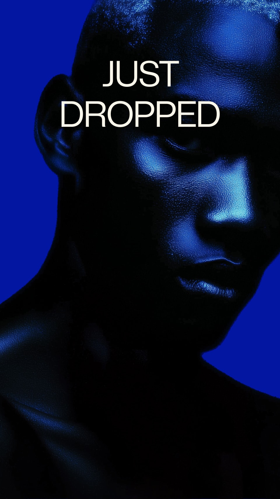 Person with blue lighting and 'JUST DROPPED' text on a blue background