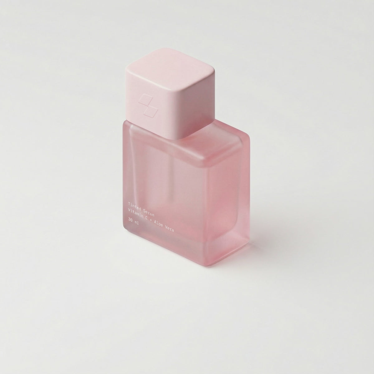 Pink perfume bottle on a light gray background